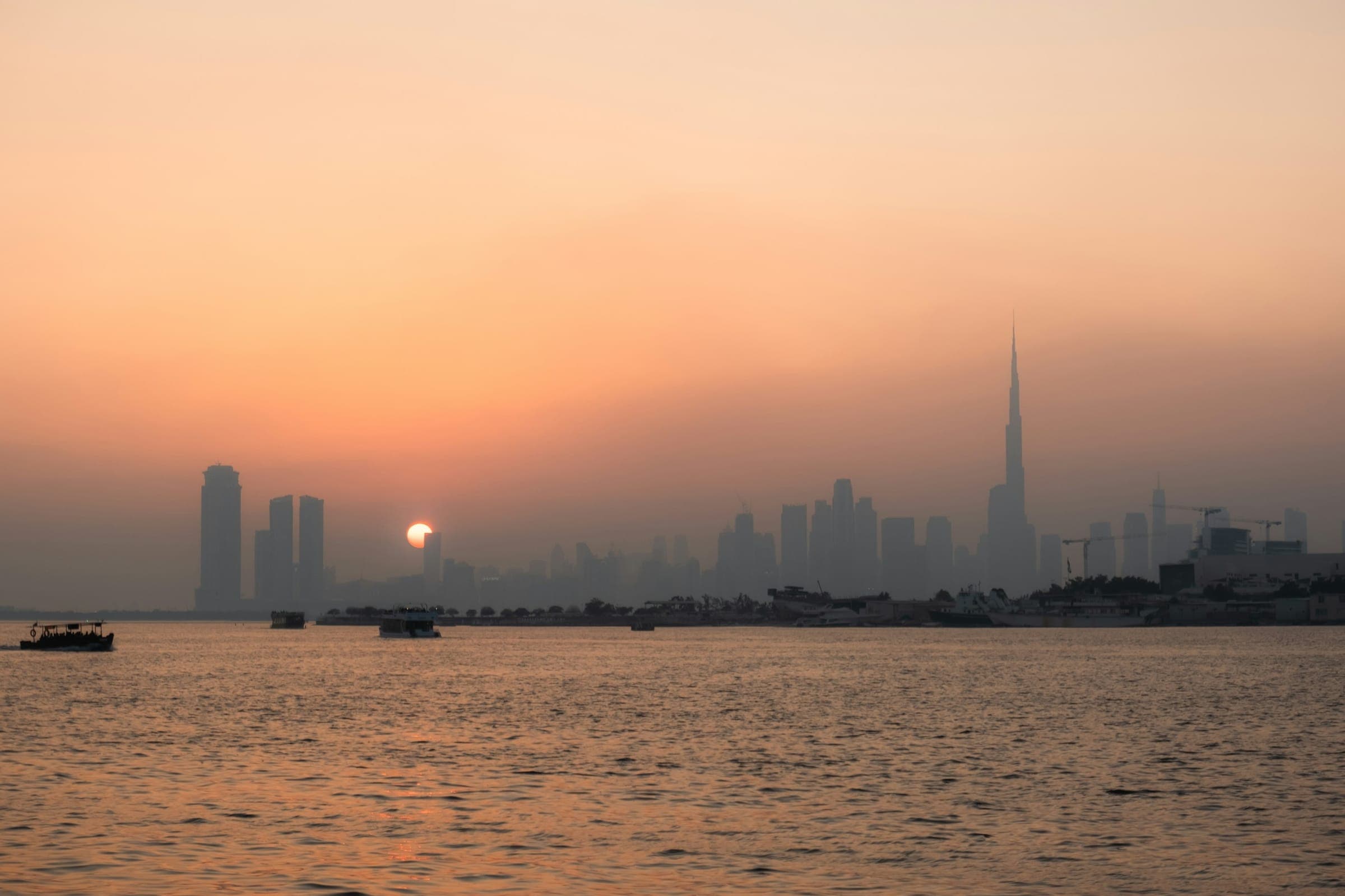 Dubai skyline at dusk, Downtown towers over the water